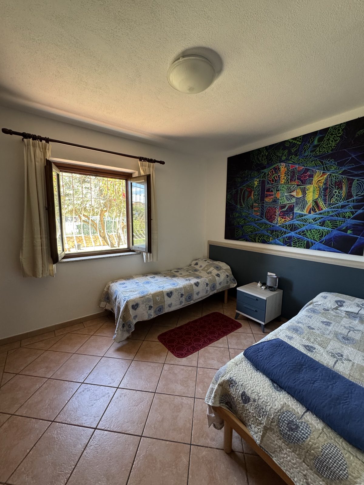 Twin bedroom with artwork at Oasi del Mare — vacation rental in San Teodoro, Sardinia