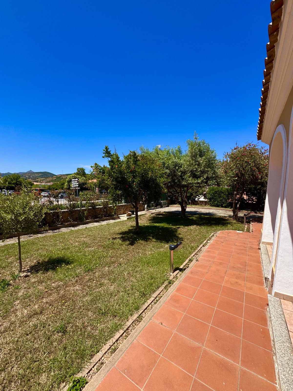 Lawn and terracotta terrace at Oasi del Mare — vacation rental in San Teodoro, Sardinia