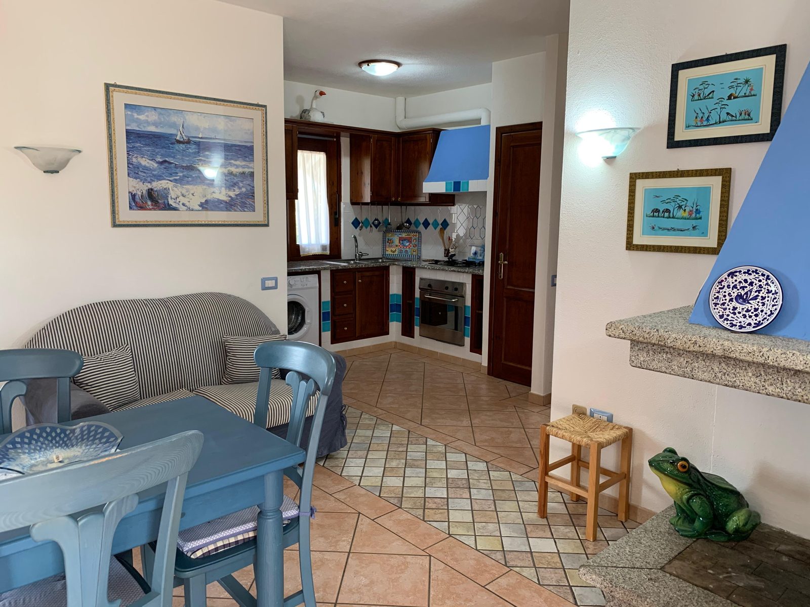 Living area with sofa and open kitchen at Terrazza sul Mare — vacation rental in San Teodoro, Sardinia