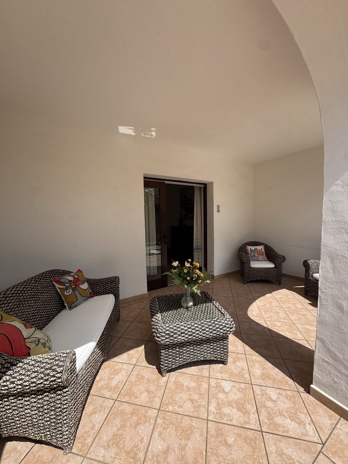Covered porch with seating area at Casa del Sole — vacation rental in San Teodoro, Sardinia