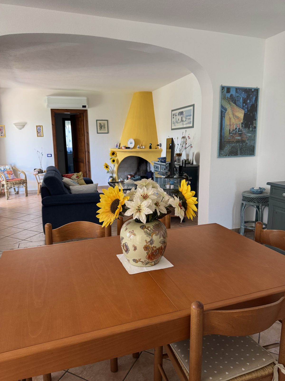 Dining table and fireplace at Oasi del Mare — vacation rental in San Teodoro, Sardinia